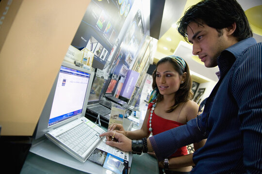 Couple selecting a computer 