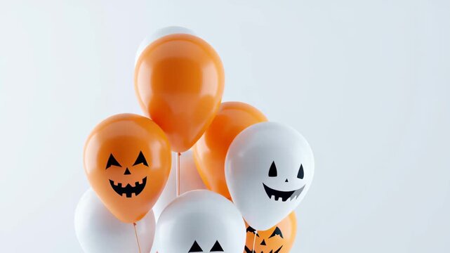 Halloween Balloons: A festive arrangement of orange and white balloons, adorned with playful ghost and jack-o'-lantern faces, evokes the spirit of Halloween and spooky celebrations.