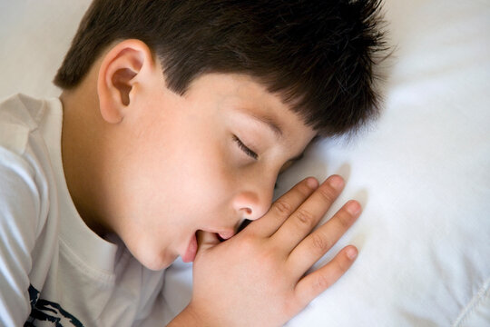 Boy sleeping with thumb in his mouth 