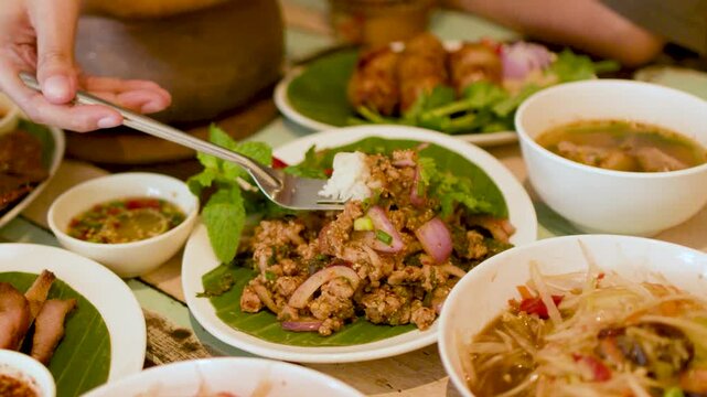 Traditional Thai Isan Meal with Larb Moo and Papaya Salad