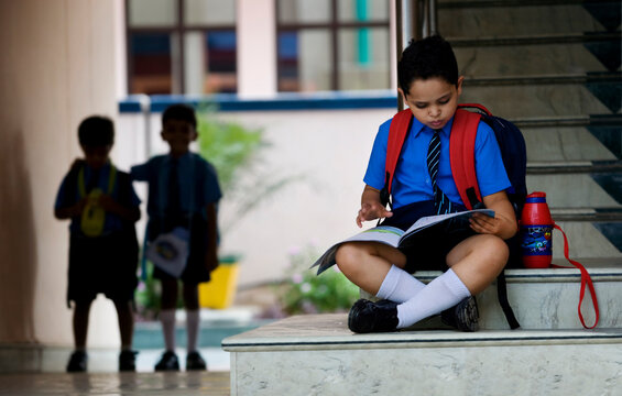 School boy sitting on the stairs 