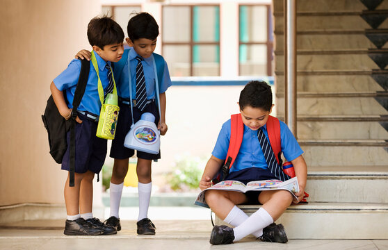 School boy looking at a book 