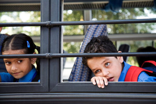 School children sitting in a school bus 