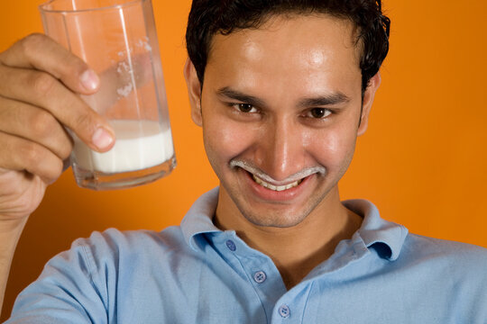 Man drinking a glass of milk 