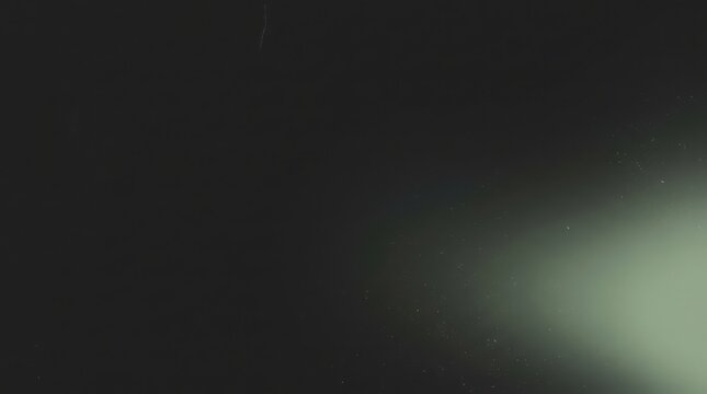 Dust particles floating in beam of light against dark background creating ethereal and atmospheric visual ideal for overlays or abstract effects.