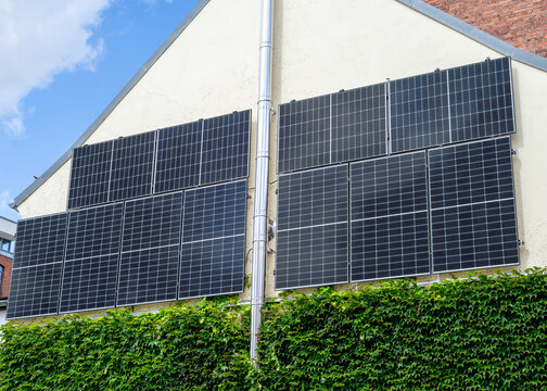 Solar Module Mounted on a House Wall in the City &ndash; Renewable Energy and Sustainable Urban Living Concept