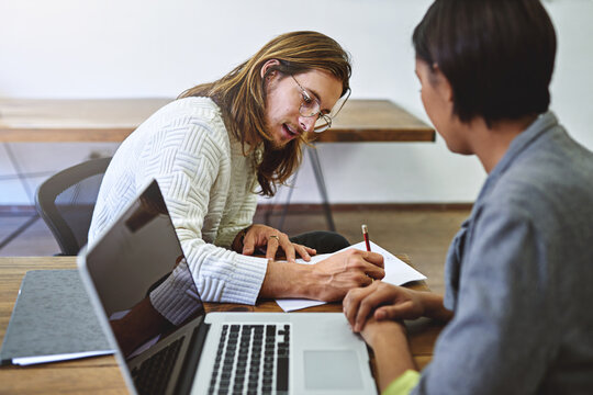 Business, people and writing in office with laptop, research and feature for press release. Team, reading and document in workplace with pc, proofreading and interview questions for story publication