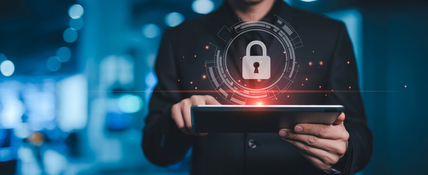 Man using tablet with digital security padlock icon and network grid overlay.