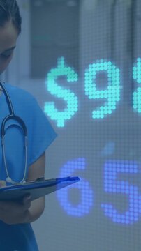 Writing on clipboard over financial data animation, medical professional in office