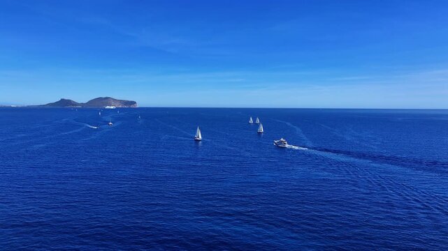 Aerial view of sailboat in the deep blue sea in Sardinia, Italy