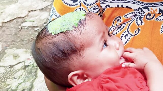Traditional practices often employ finely pounded green herbal remedies&mdash;such as castor leaves, celery leaves, cucumber, or blends of traditional spices&mdash;to lower a baby's temperature during a fever.