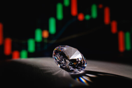 Faceted diamond casting shadow with trading chart in background