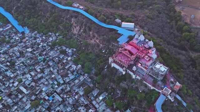 Majestic Drone View of Shri Radha Rani Temple on the Hills of Barsana, Uttar Pradesh Surrounded by Traditional Village Homes and the Scenic Braj Landscape