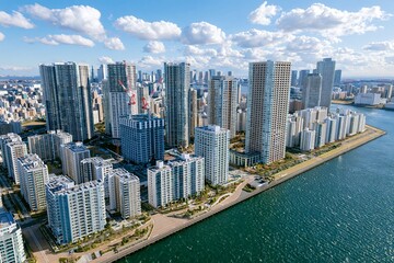 Fototapeta premium 晴天の東京湾岸にそびえ立つ高層ビルと海の風景