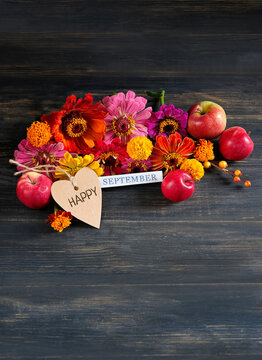 September calendar. calendar block with September month, paper heart card, colorful flowers and red apples close up on wooden table background. Happy September concept. Back to school, Knowledge Day