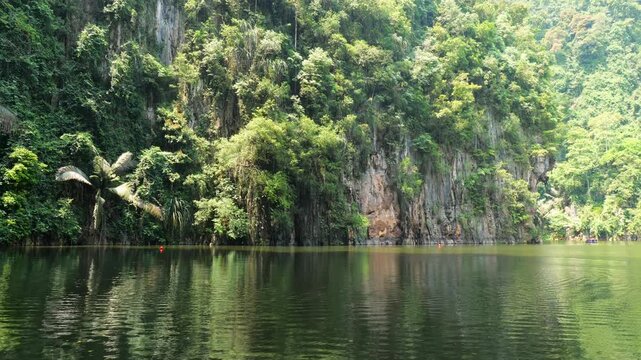 Tasik Cermin, Mirror Lake, with limestone cliff reflections in still green water, Ipoh, Malaysia