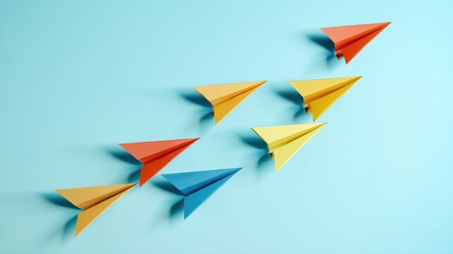 Colorful paper planes flying in formation on light blue background