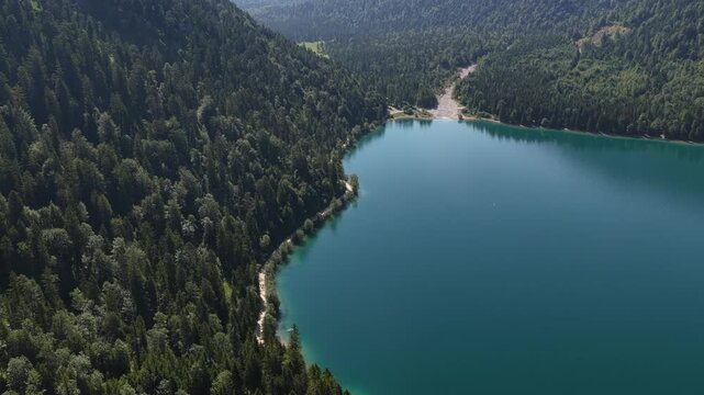 Plansee turquoise alpine lake Reutte Tyrol district Austria drone aerial surrounded by forest