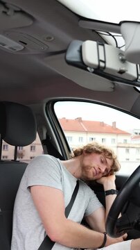 Vertical screen young man sleeps in his new car since he has nowhere else to sleep revealing housing insecurity loneliness and the harsh reality of temporary homelessness