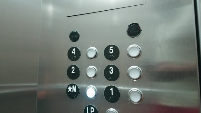Stainless steel elevator button panel inside building elevator car