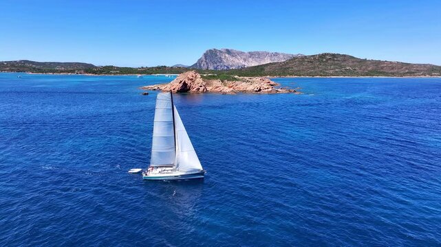 Aerial view of sailboat in the sea near Tavolara island, Sardinia, Italy