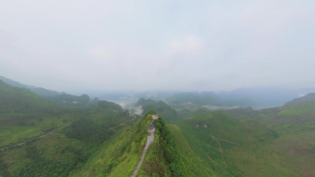 Drone view landscape of green mountains, footpath, Chinese style pavilion in Fengtang village, Hechi, Guangxi, China, 4k real time footage travel concept b roll shot.
