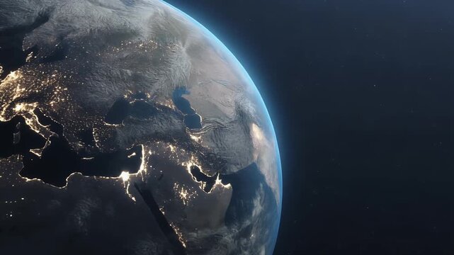 View of Earth from space at night, showing illuminated continents and stars.