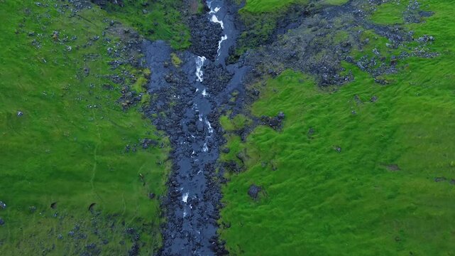 Top Down Aerial View of Mountain Stream and Road Near Fossa Waterfall in Faroe Islands