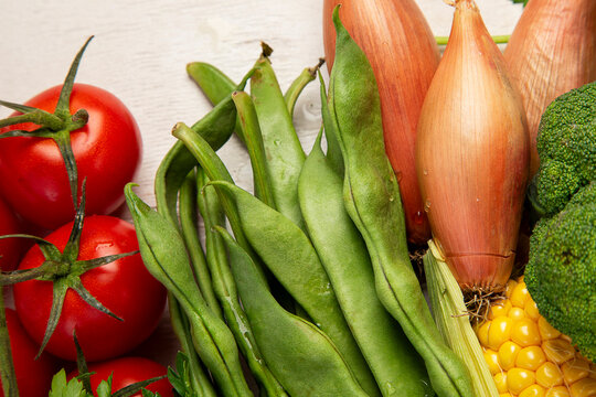 Different fresh vegetables as background.