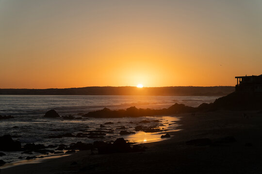 The sun sets over the rocky beach at Keurboomstrand in South Africa