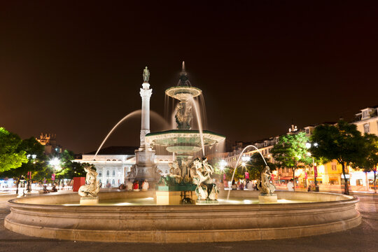 Europe, Portugal, Lisbon, Baixa, View of Bronze fountain and statue of King Pedro IV in Rossio at night