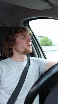 Vertical screen stylish driver cruises with quiet confidence and a proud expression presenting a cool charismatic image while enjoying a smooth ride through urban traffic
