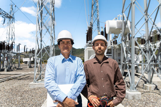 Coworkers stand at an outdoor electrical substation in Loja Ecuador