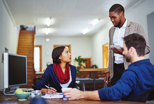 Creative, people and meeting in office with tablet, research and discussion for press release. Team, writing and document in workplace with tech, proofreading and interview notes for story manuscript