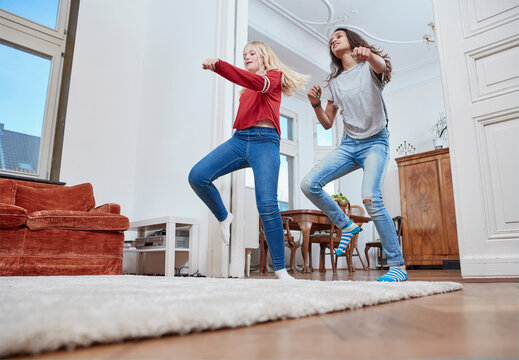 Two girls dancing at home
