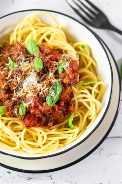 Bowl of spaghetti features salsiccia sausage and fresh basil