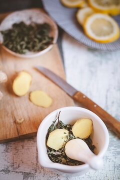 Preparing healthy peppermint and ginger tea in a mortar