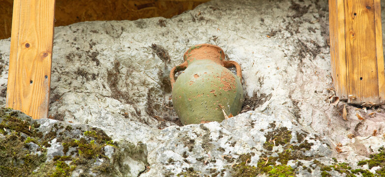 Ancient clay jugs in the forest.