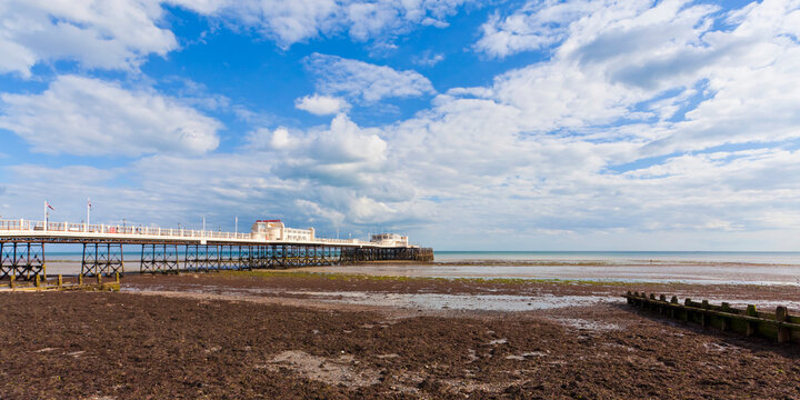 Worthing Pier at low tide on the beach in Sussex England