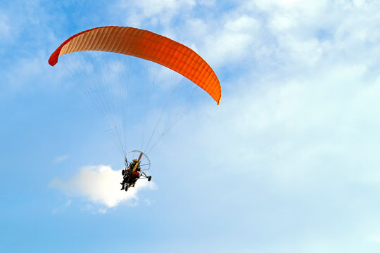 Paramotor Flying in a Blue Sky