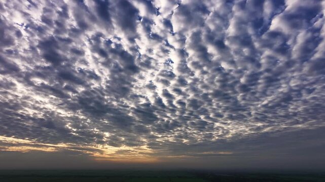 Aerial view of dramatic mackerel sky over rural landscape at sunrise