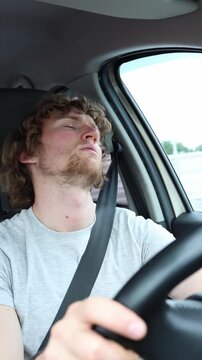 Vertical screen driver falls asleep behind the wheel then suddenly wakes up in shock after realizing he dozed off while the car continued moving through dangerous traffic