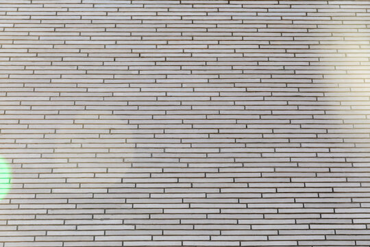 Modern grey brick wall texture background of modern building facade. Real Photo