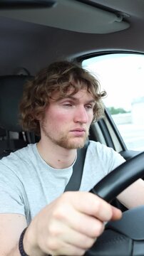 Vertical screen tired driver falls asleep behind the wheel while the car keeps moving through traffic creating a dangerous risk of collision during a lengthy road journey