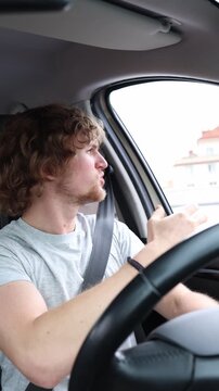 Vertical screen driver stops his sedan opens the side window and angrily shouts at another motorist after a tense road conflict during heavy traffic on a busy city street