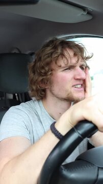 Vertical screen focused driver hears a repetitive knocking sound while the car is moving and listens closely trying to determine which vehicle part has developed faults