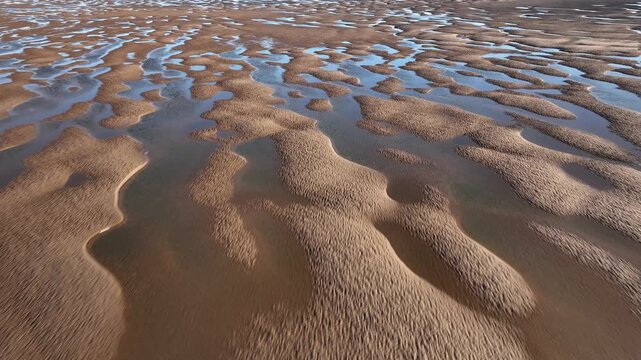Undulating Sand Patterns And Tidal Pools At Golden Hour. Fleetwood, Lancashire, England, UK.