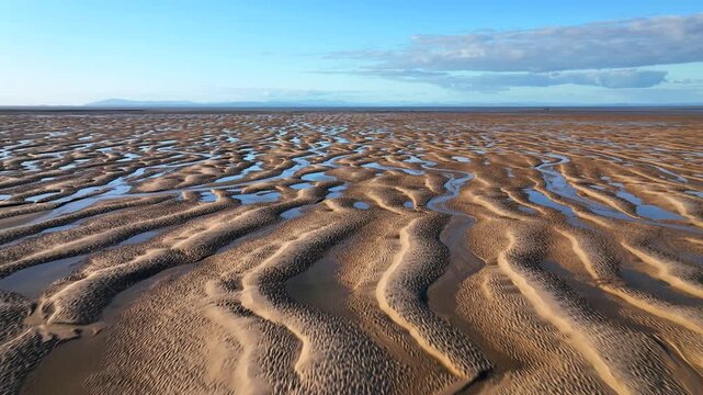 Sky Reflected In Tidal Pools At Golden Hour. Low Flight Over. Fleetwood, Lancashire, England, UK.
