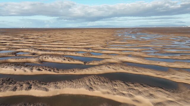 Rippled Sand With Tidal Pools At Golden Hour. Low Fast Flight Over. Fleetwood, Lancashire, England, UK.