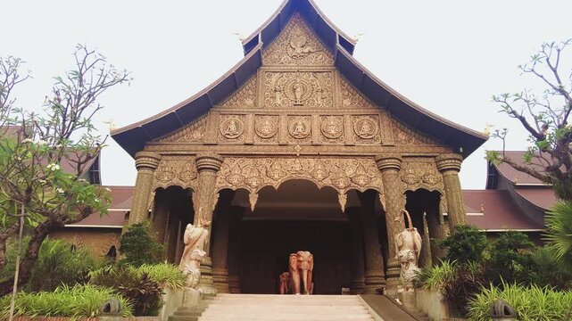 Lao Art Museum main entrance exterior. Giant golden building triangular roof.